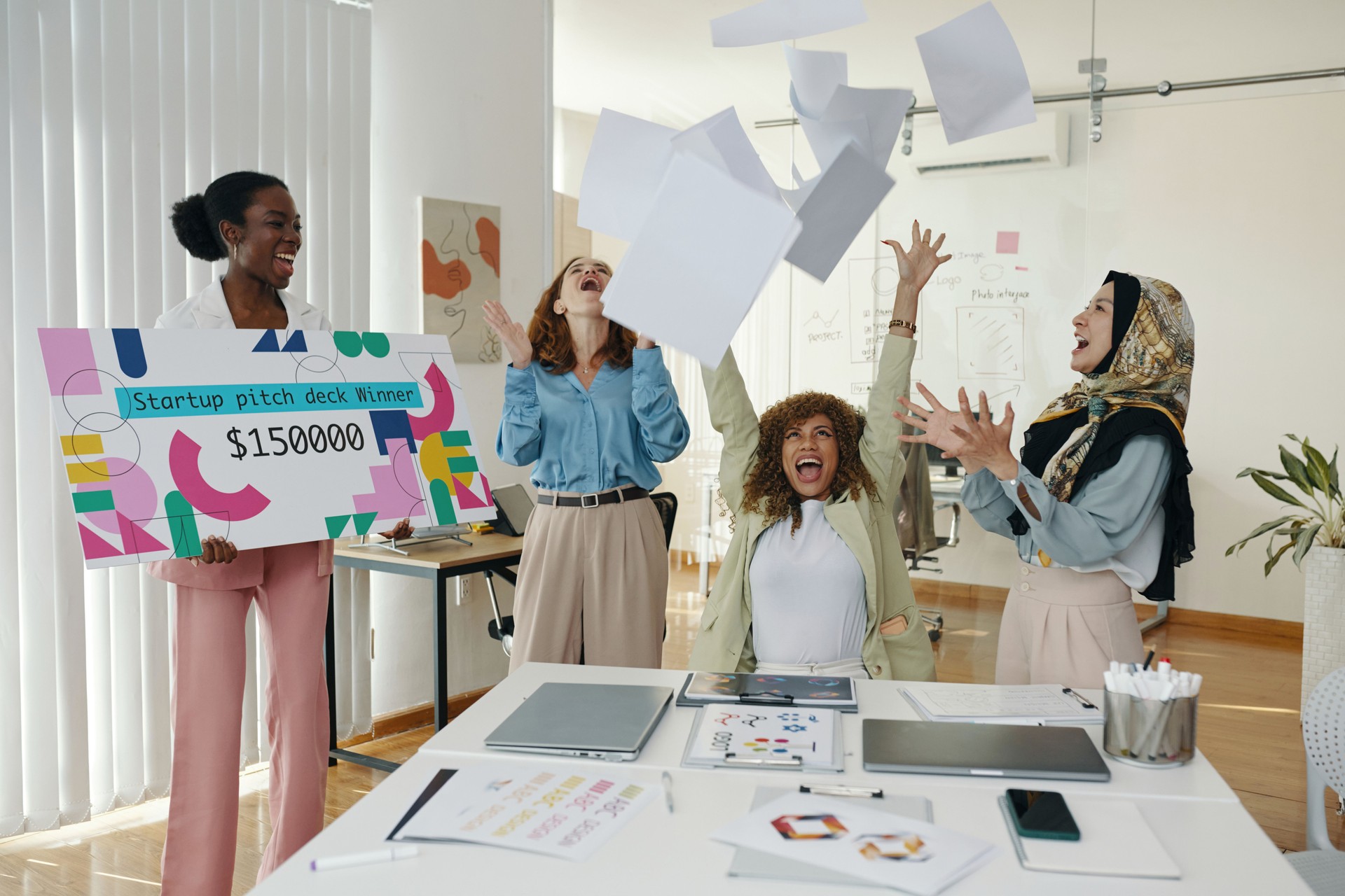 Celebrating Startup Pitch Deck Winner in Office Meeting